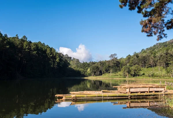 Tranquil lake with the wooden raft.