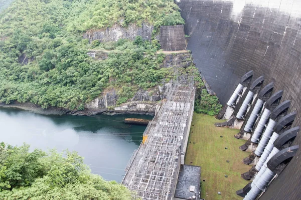 Hydroelectric power plant under the large arch concrete dam.