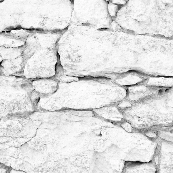Concept or conceptual white stone,rock or stone ancient or old wall texture background