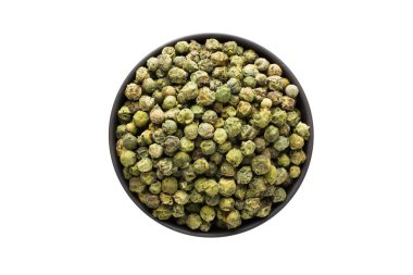 Beyaz bir arka plan üzerinde izole kase, üstten görünüm, yeşil biber tohumları. organik baharat