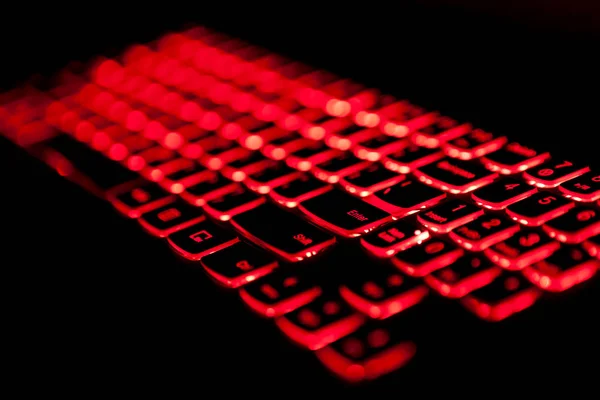 Gaming laptop keyboard red backlight with selective fockus.