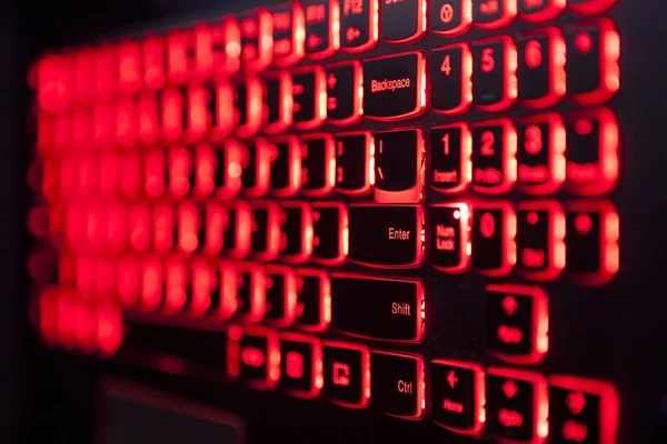 Gaming laptop keyboard red backlight with selective fockus.