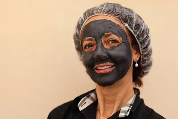 Brazilian woman smiling with clay mask Stock Photo