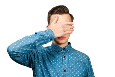 portre genç adam beyaz mavi gömlek giymiş, kapanır gözleri elleri. Beyaz arka plan üzerinde izole.