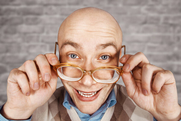 Portrait happy bald guy office worker glad to win on Brick wall white background