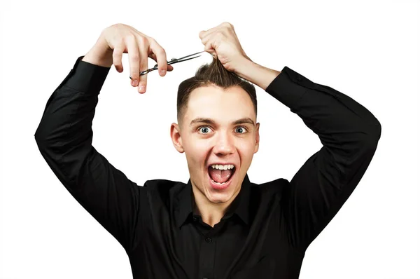 A white young guy scissors cuts his hair. Isolated on white background. — Stock Photo, Image