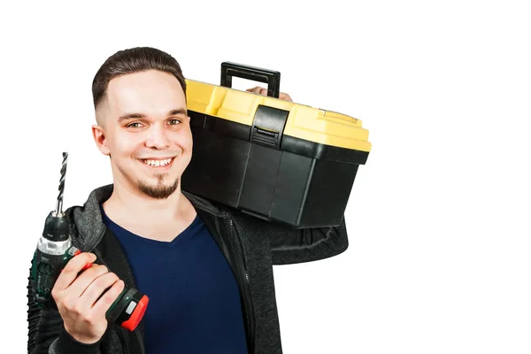 Молодий хлопець тримає коробку інструментів і викрутку, ізольований на білому тлі — стокове фото