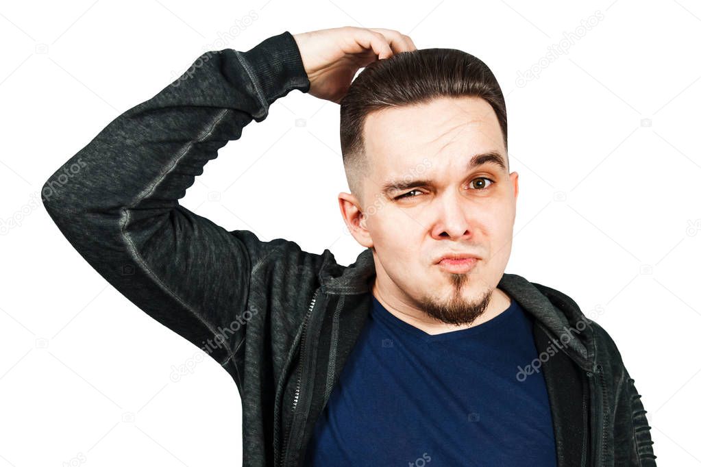 Thinking man holds hand at face, isolated on white background. Closeup portrait of young pensive guy. Caucasian male model.