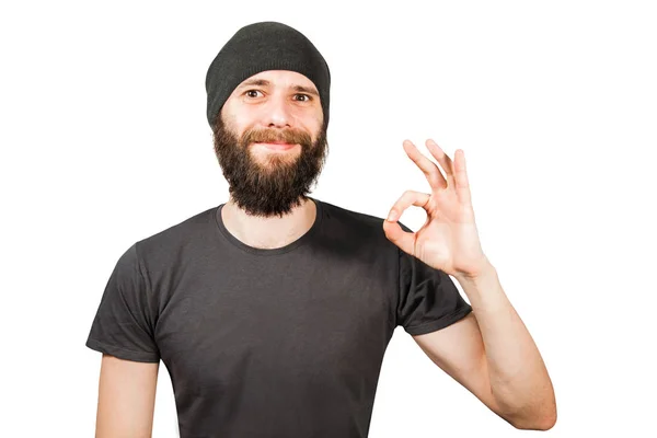 Mladý vousatý chlap v klobouku, úsměvy a show ok. Izolované na bílém pozadí — Stock fotografie