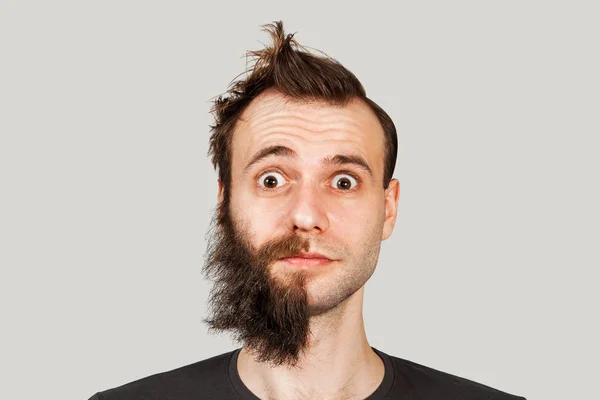 Hombre con barba medio afeitada sorprendido con ojos anchos sobre fondo gris —  Fotos de Stock