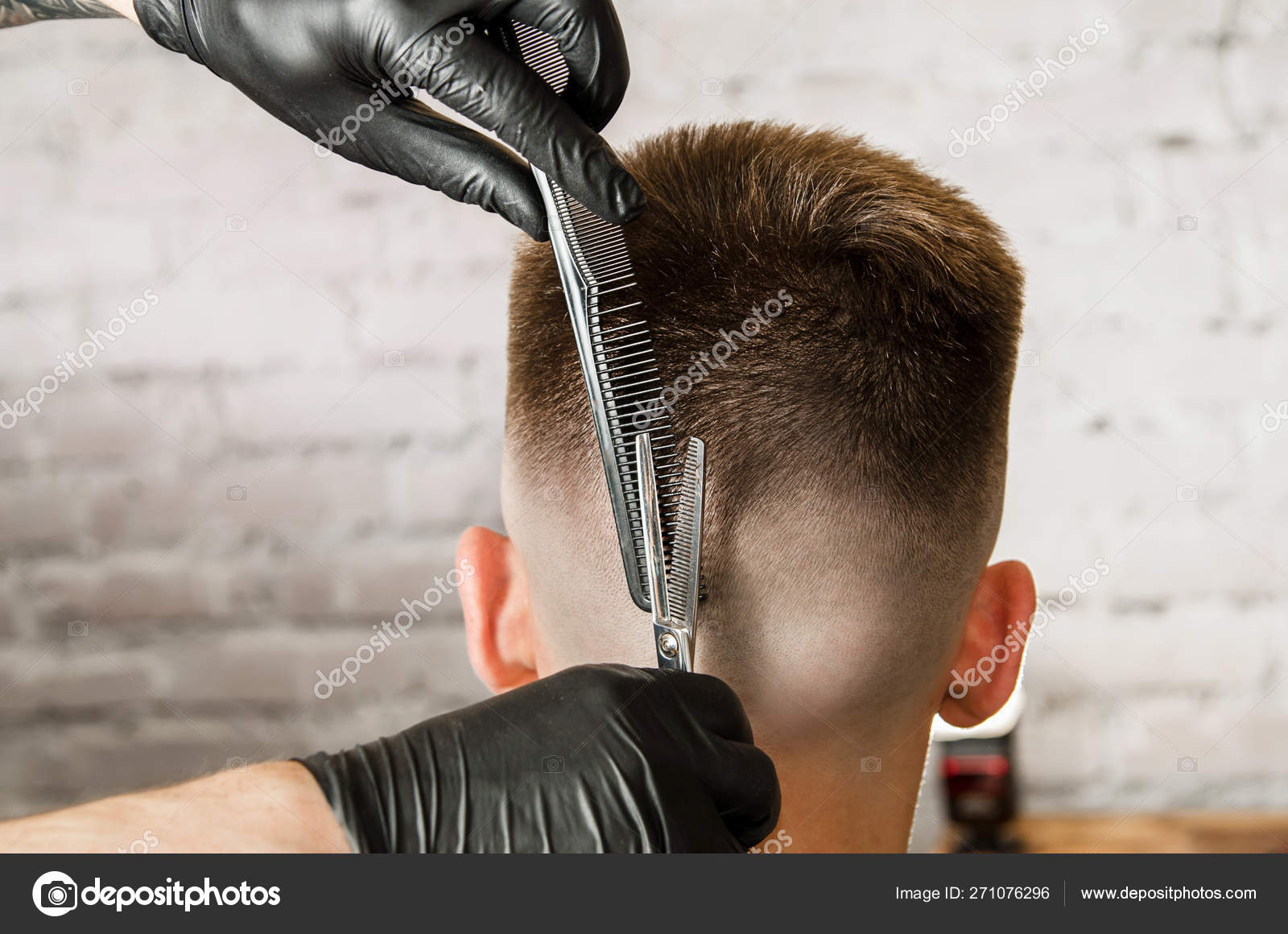 Barber hand in gloves cut hair and shaves young man on a brick wall  background. Close up side portrait of a guy, back view Stock Photo by  ©gum92 271076296