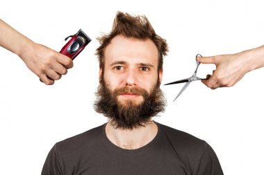 hand with clipper and hand with scissors cut overgrown unshaven guy with a beard on a white isolated background clipart