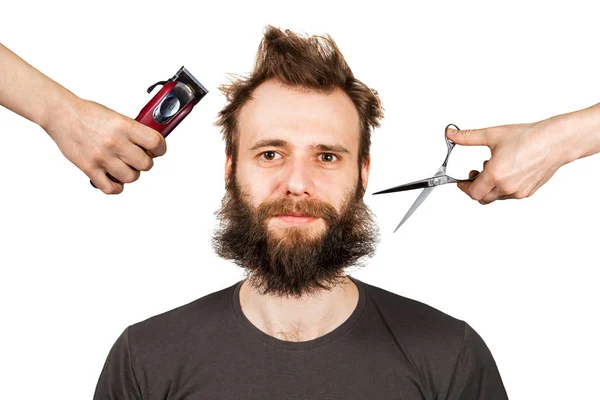 Hand with clipper and hand with scissors cut overgrown unshaven guy with a beard on a white isolated background — Stock Photo, Image