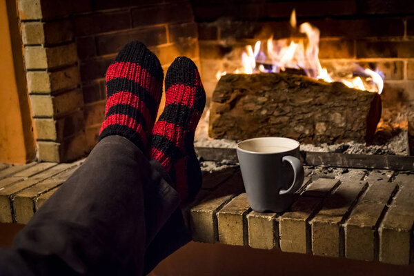 womans feet while she is warming in a fireplace