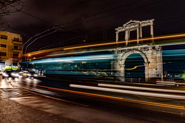 stock image Light trails of moving cars under Hadrian gate