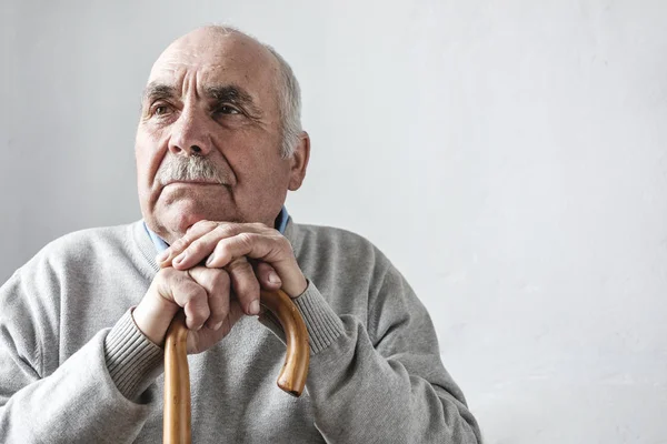 Grey haired elderly man with mustache thinking — Stock Photo, Image