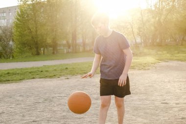 Çocuk basketbol oynuyor.
