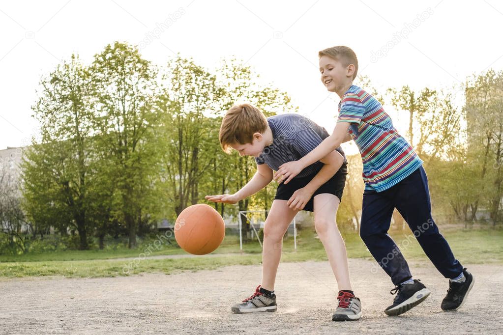 Two young boys enjoying a game of basketball