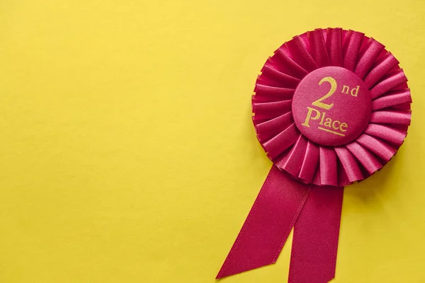 2nd Place red winners ribbon rosette on yellow — Stock Photo, Image
