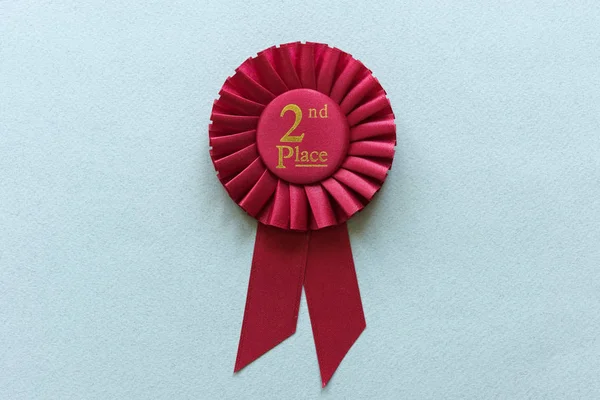 Red 2nd Place Winners rosette on light blue — Stock Photo, Image