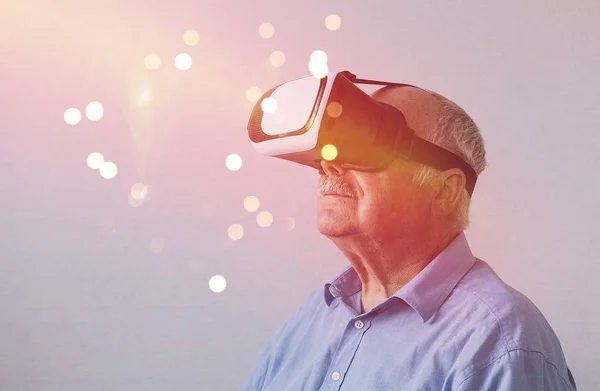 Oudere man in verwondering bij Virtual Reality Stockfoto