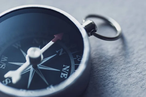 Black compass close-up shows the direction to move. — Stock Photo, Image