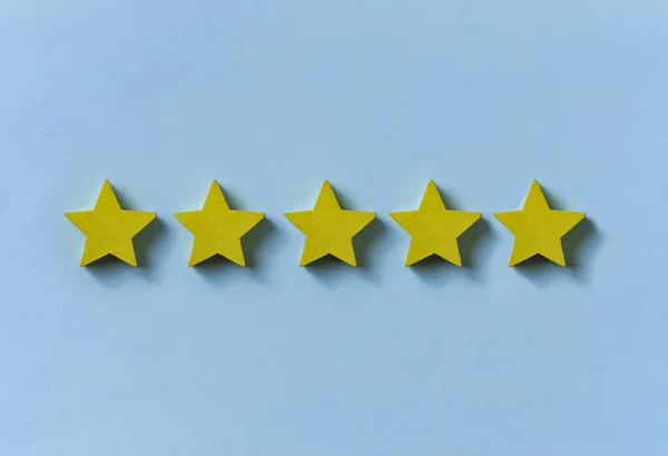 Line of five gold stars on blue — Stock Photo, Image