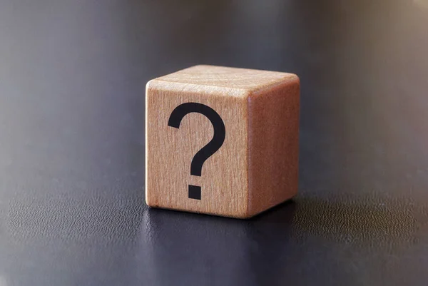Question mark on a small wooden block — Stock Photo, Image