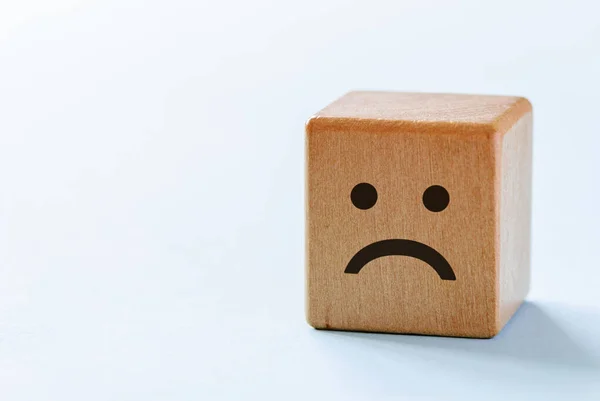 Small wooden dice with sad emotion — Stock Photo, Image