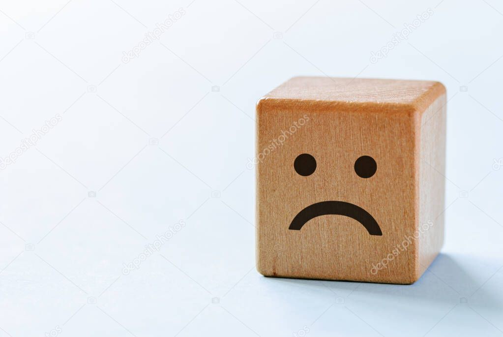 Small wooden dice with sad emotion