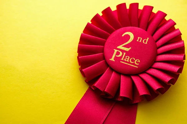 Red Ribbon Rosette Second Place Runner Competition Race Yellow Background — Stock Photo, Image