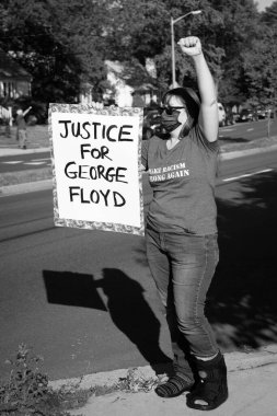 A demonstrator protests the killing of George Floyd and shows support for the Black Lives Matter movement in Arlington, Virginia on June 1, 2020  clipart