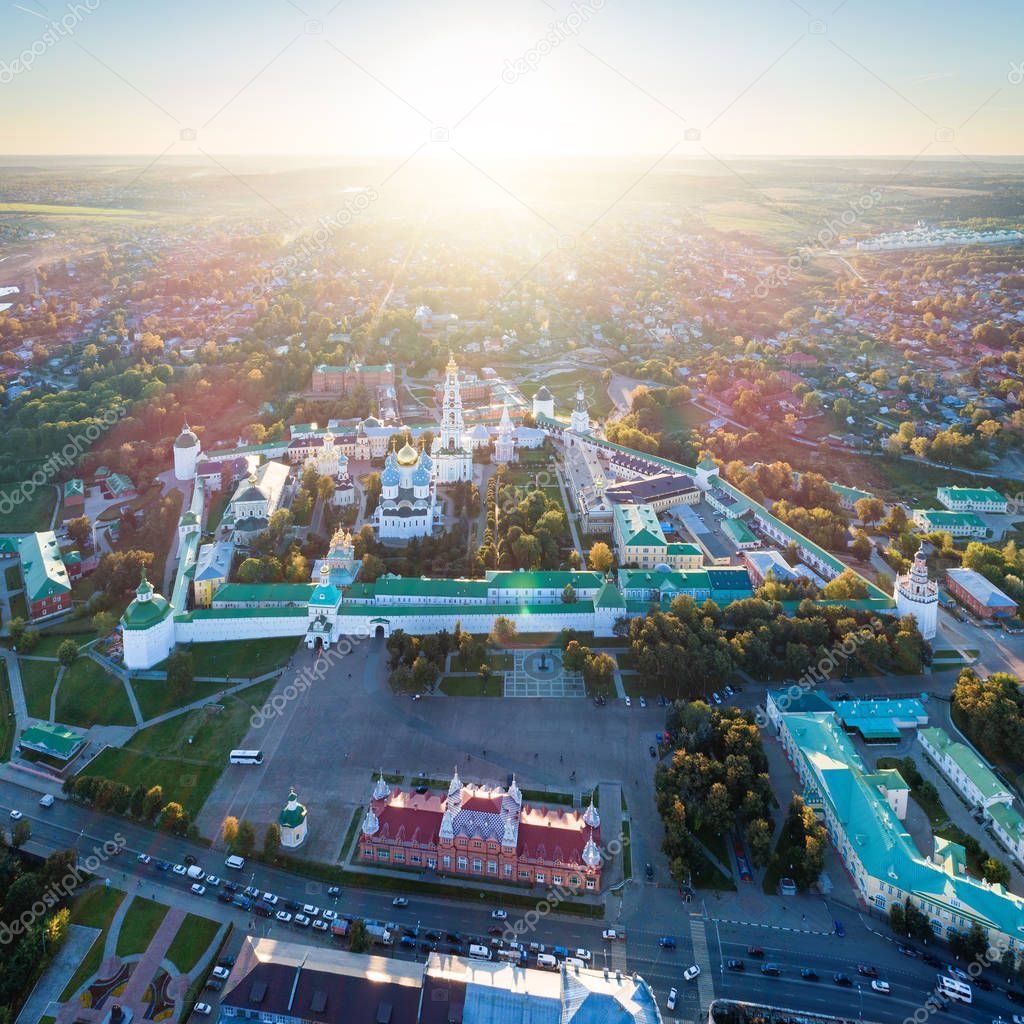 Aerial view on Trinity St. Sergy Monastery at autumn sunset with flares. Sergiev Posad, Russia