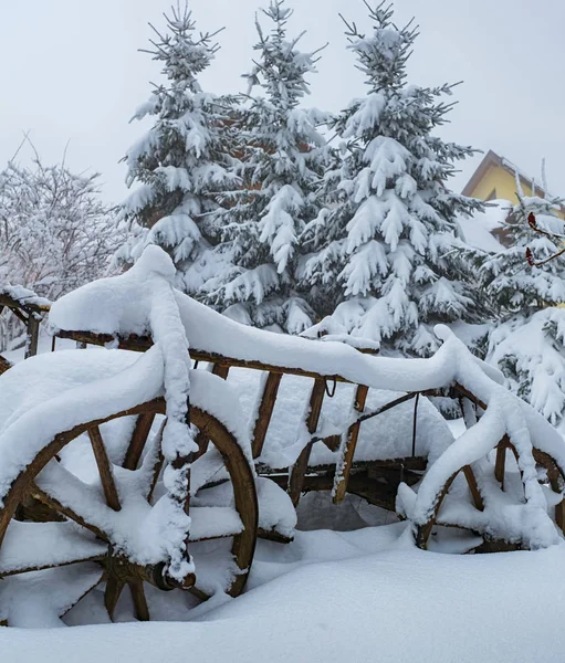 Vieux chariot en bois recouvert de neige — Photo