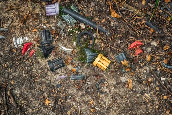 Műanyag eltemetve a talajban az erdőben, talajszennyezés — Stock Fotó