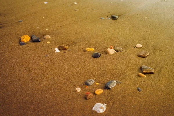 Mořský písek a kamenitý břeh, textura pozadí na nábřeží — Stock fotografie