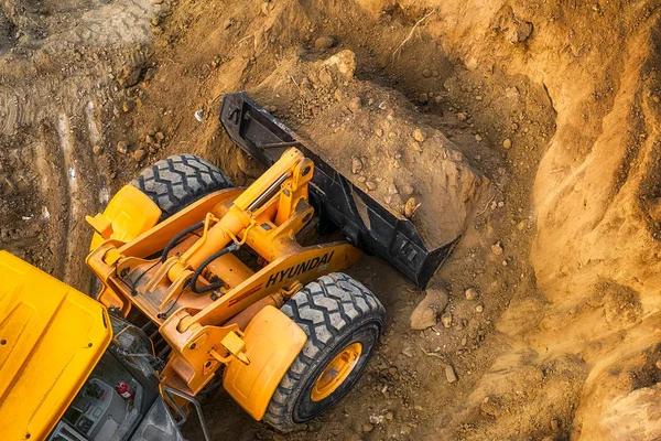 The modern excavator performs excavation work on the constructio
