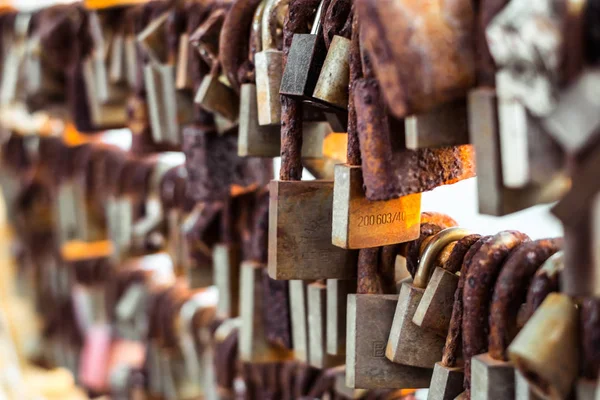 Rows of wedding locks hanged on the railing of love bridge — Stock Photo, Image