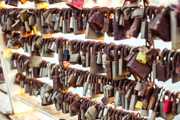 Rows of wedding locks hanged on the railing of love bridge — Stock Photo, Image