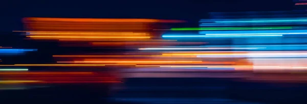 Аннотация Rainbow light trails on the dark background — стоковое фото