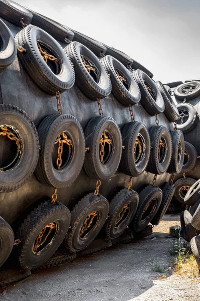 A huge Marine Pneumatic heavy rubber fender surrounded by tires