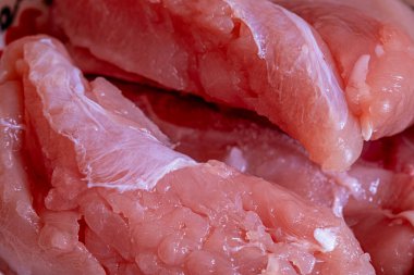 Pişmemiş taze çiğ tavuk filetosu parçalarının yakın çekimi.