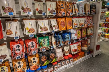 Chongqing, China  May 09, 2025. a vibrant snapshot of a well-stocked supermarket aislewith shelves filled top to bottom with a variety of goods