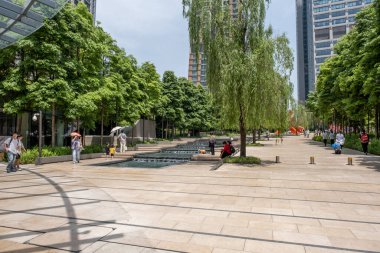 Chongqing, China - May 01 2025. Walking through a mega city with skyscrapers and charming historic buildings, in a vibrant tapestry of cultures, The streets are alive with a mix of locals and tourists