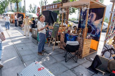 Chongqing, China - May 01 2025. Walking through a mega city with skyscrapers and charming historic buildings, in a vibrant tapestry of cultures, The streets are alive with a mix of locals and tourists