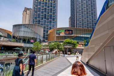 Chongqing, China - May 02 2025. Walking through a mega city with skyscrapers and charming historic buildings, in a vibrant tapestry of cultures, The streets are alive with a mix of locals and tourists
