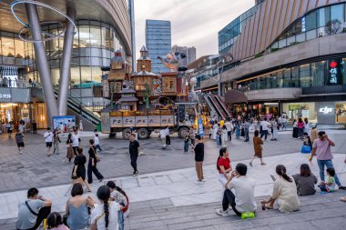 Chongqing, China - May 02 2025. Walking through a mega city with skyscrapers and charming historic buildings, in a vibrant tapestry of cultures, The streets are alive with a mix of locals and tourists
