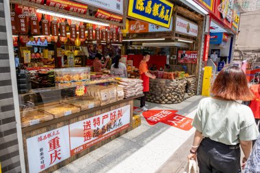 Chongqing, China - May 01 2025. Walking through a mega city with skyscrapers and charming historic buildings, in a vibrant tapestry of cultures, The streets are alive with a mix of locals and tourists