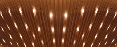 Dikdörtgen şeklinde paneller içeren modern bir mimari tavan. Küçük, eşit aralıklı ışıklar tavana gömülü, yumuşak, dağınık bir parıltı bırakarak.
