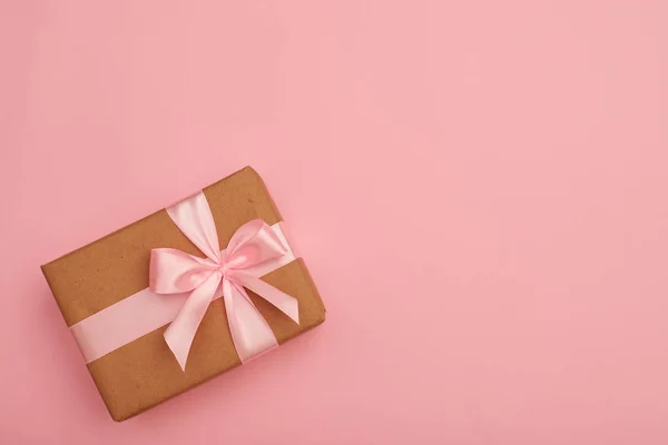 Boîte cadeau enveloppée avec ruban rose noeud — Photo